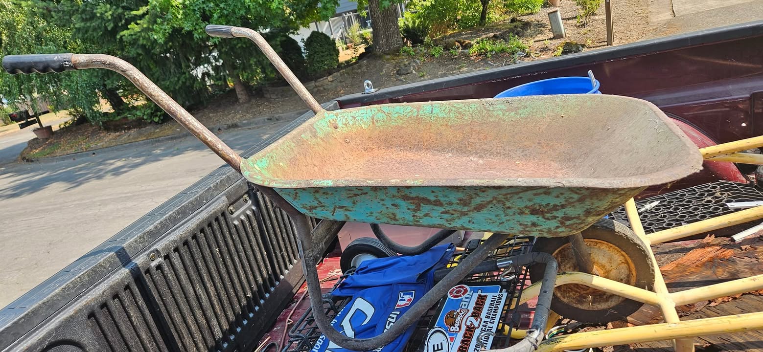 This vintage yard art wheelbarrow is up for grabs for  this would look great in your garden